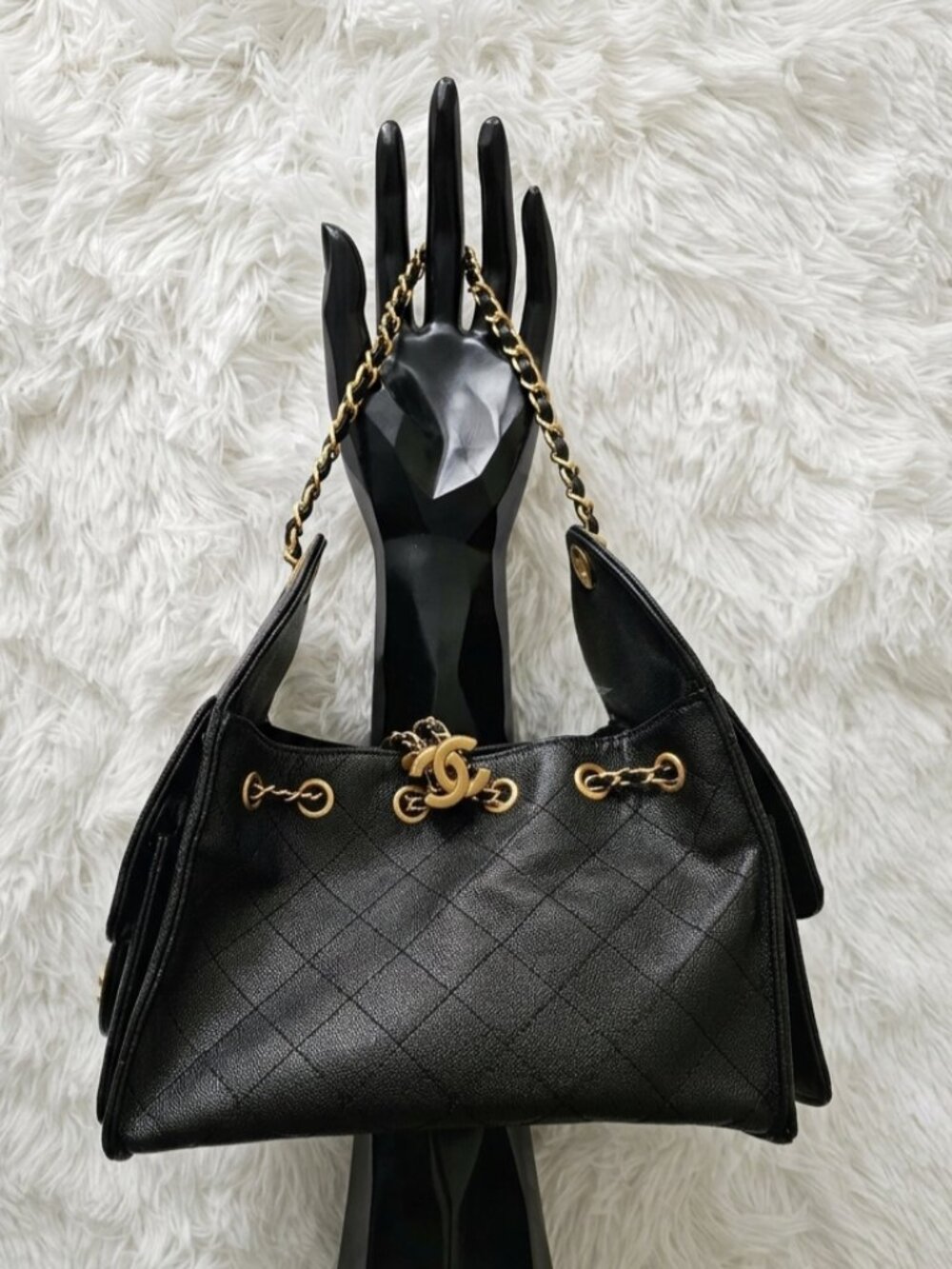 Stylish black bag with chain details.